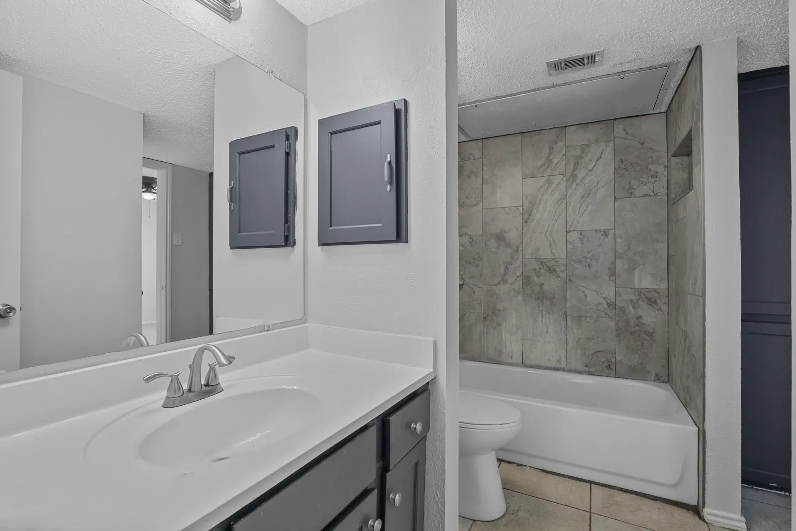 Full bathroom with tub-shower and vanity