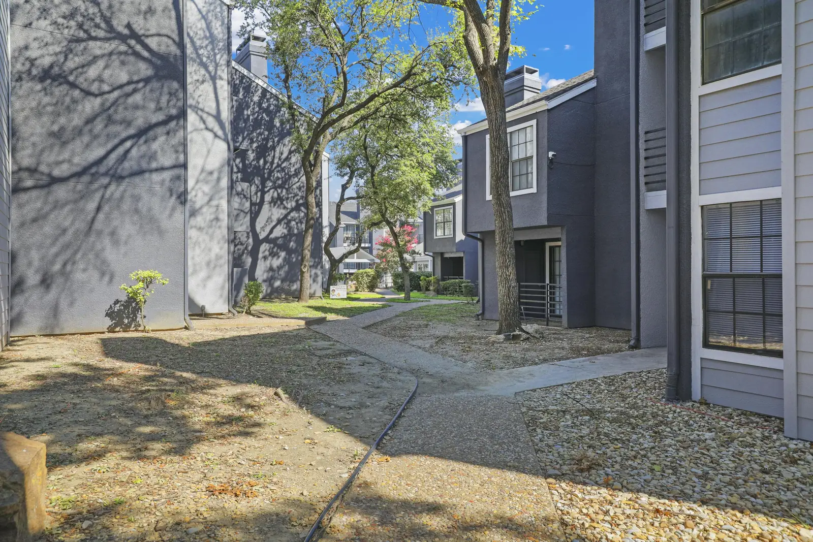 Landscaped walkway between apartment buildings
