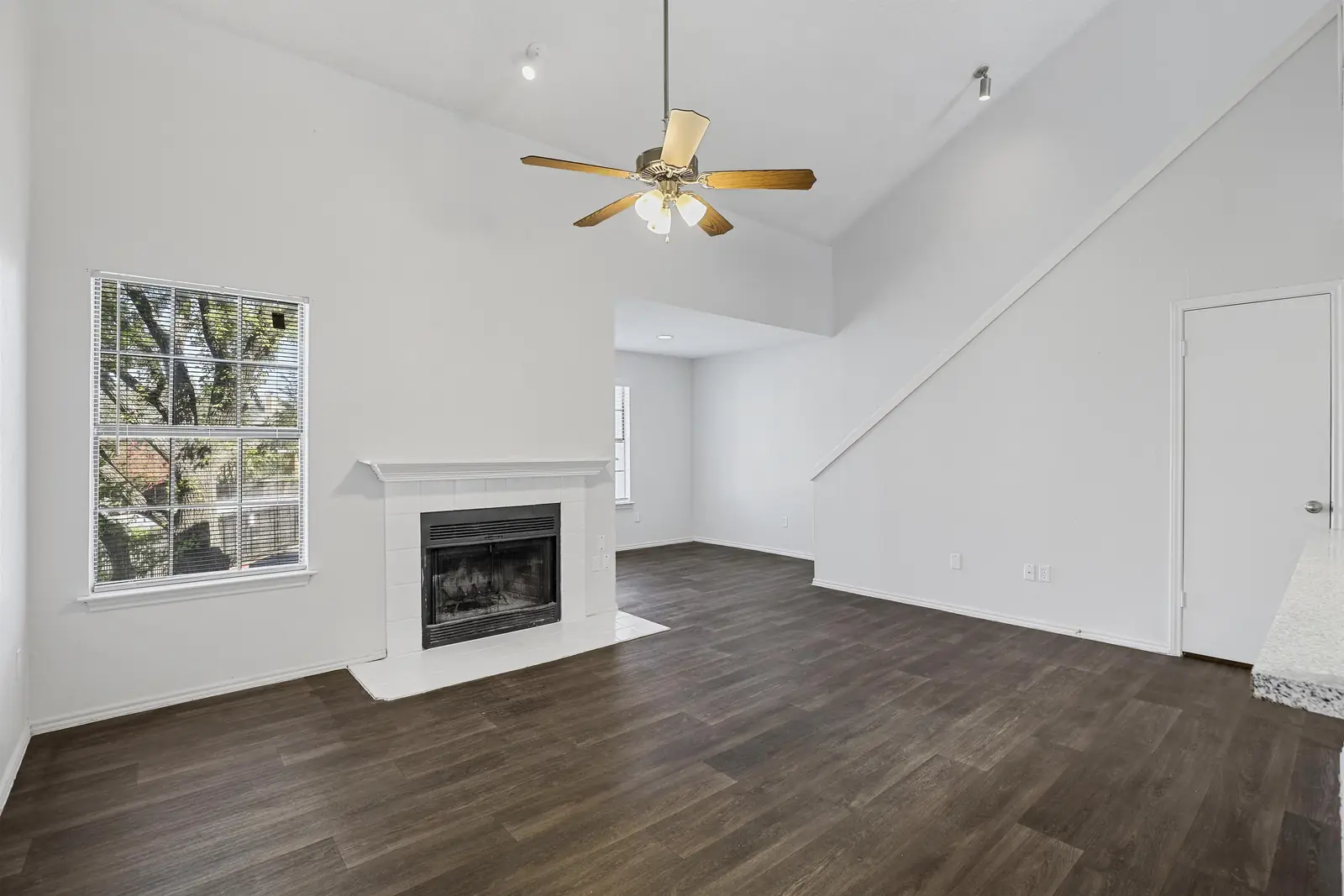 Two-storey townhome living room with fireplace and wood-style flooring