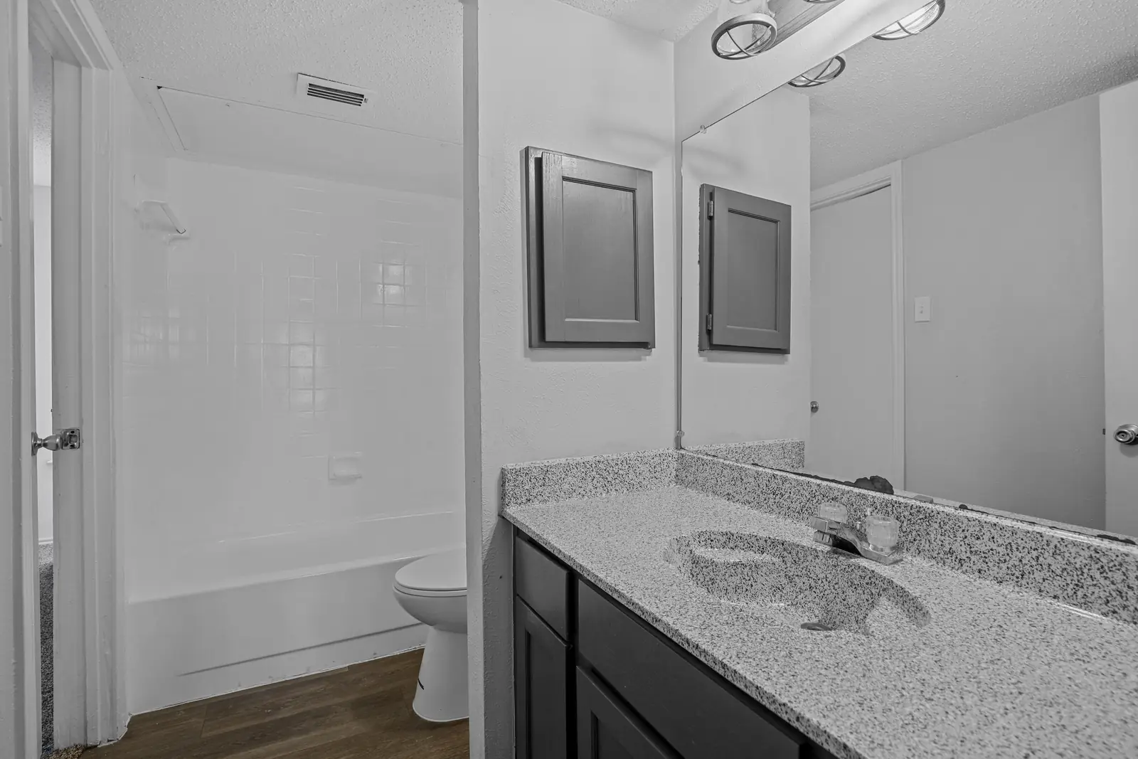 Bathroom with stone-look vanity and tub-shower