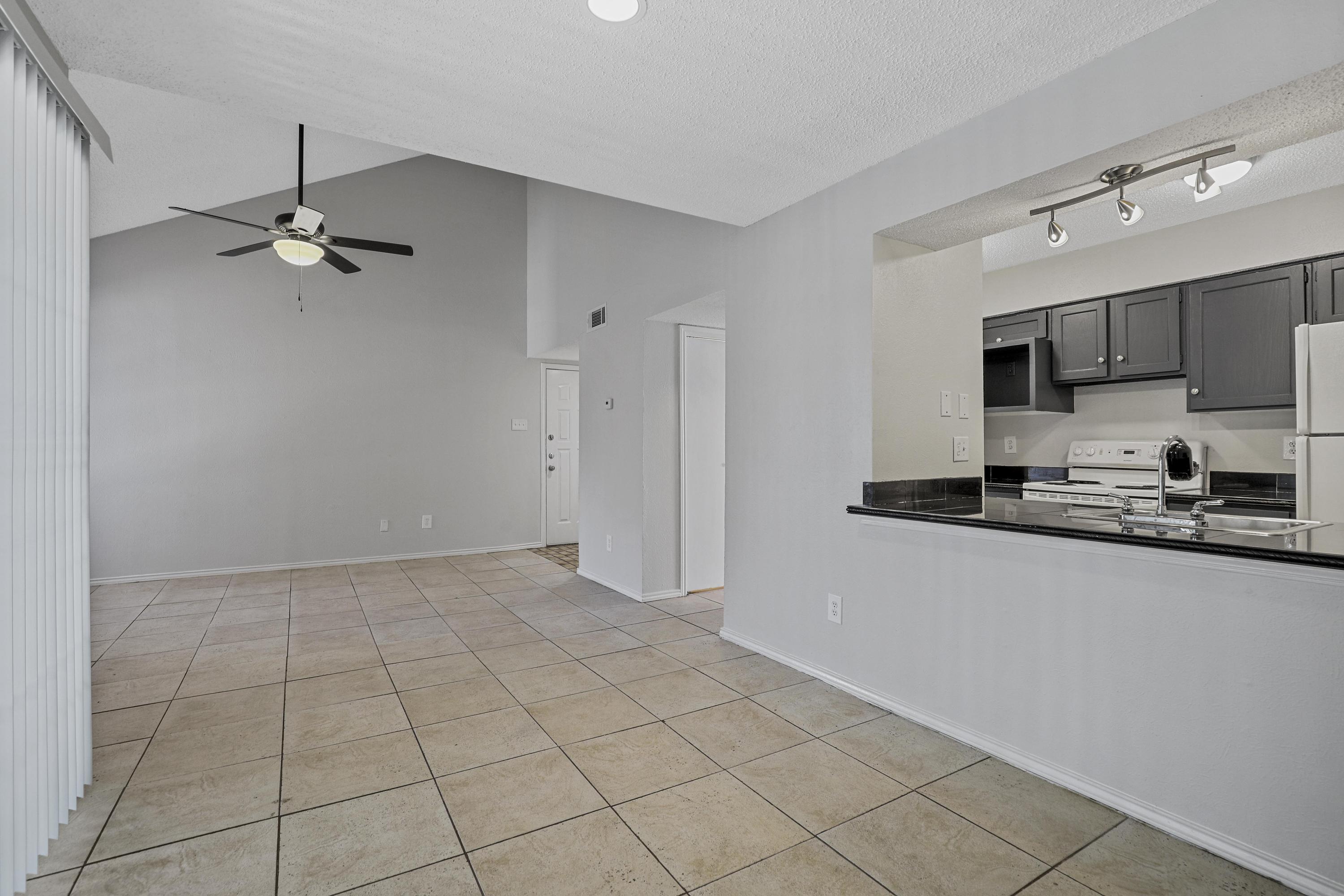 Bright open living room and kitchen at Village Oaks